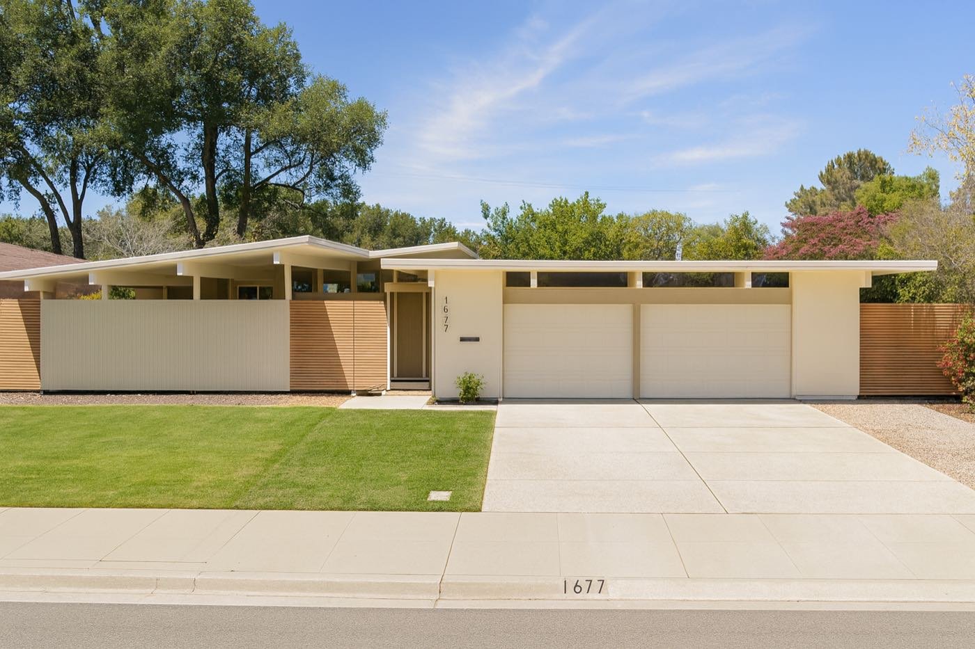 A tan Eichler with clerestory windows and horizontal wood screen fencing, Fairbrae, Sunnyvale